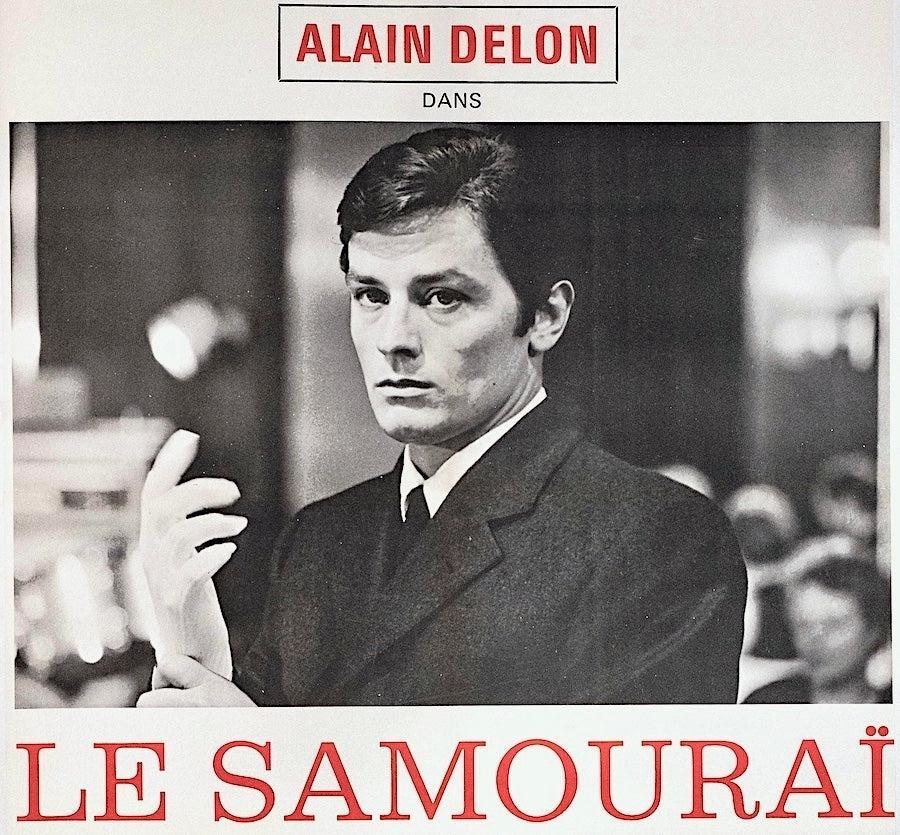 Vintage Le Samouraï movie poster featuring man in suit putting on gloves, black and white design