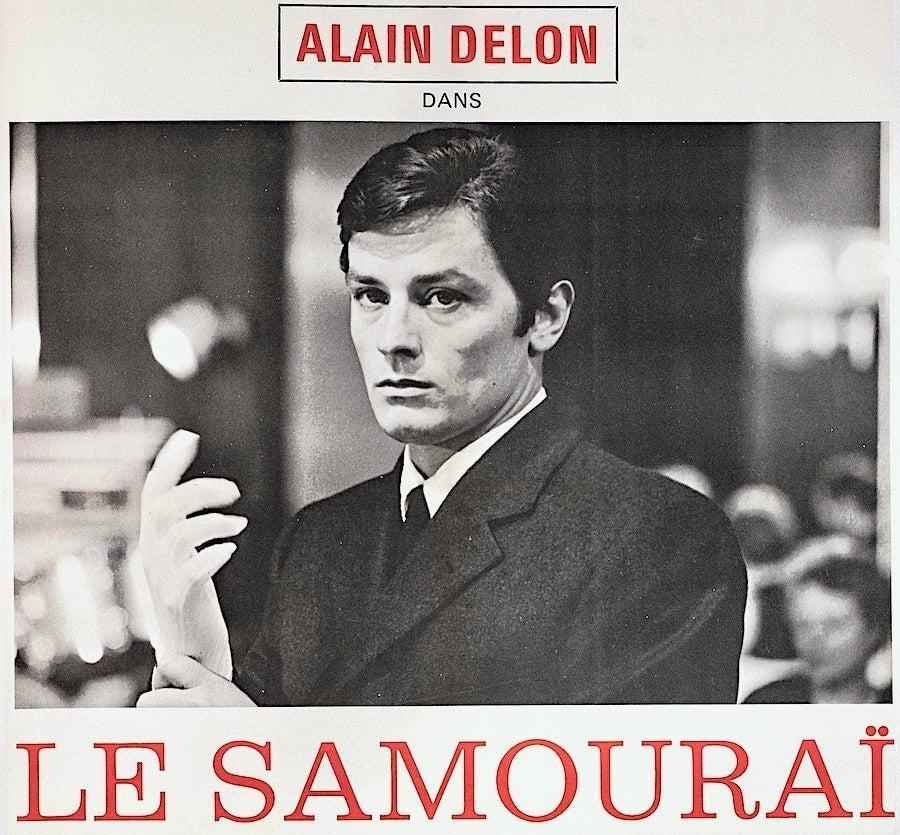 Vintage Le Samouraï movie poster featuring man in suit putting on gloves, black and white design